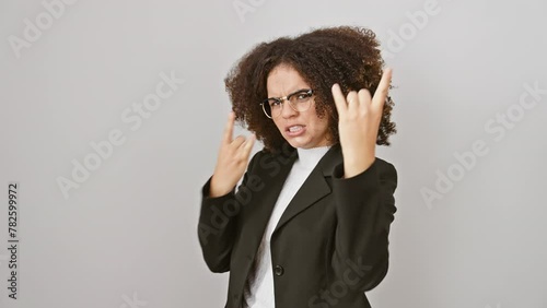 Rockin' hispanic woman with curly hair throws heavy metal gesture, owning her music star status, crazy fun expression ablaze, isolated on white background photo