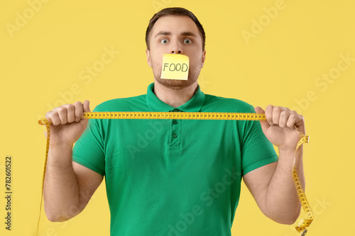 Young man with taped mouth ...