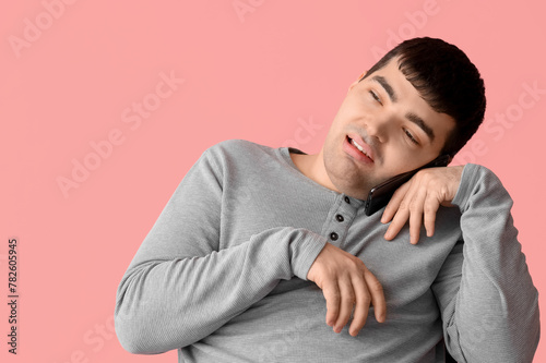 Young man on pink backgroun...