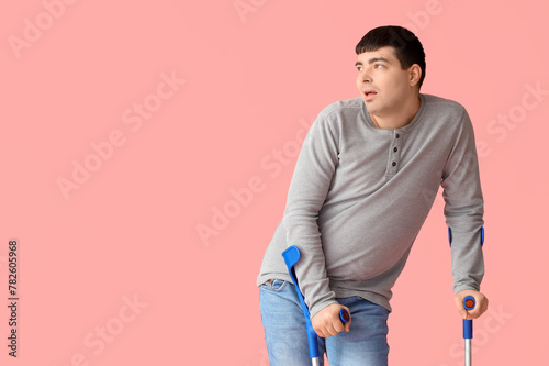 Young man with crutches on ...