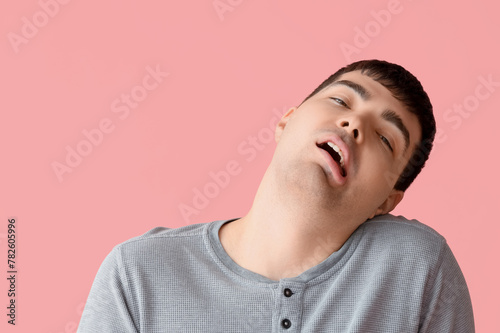 Young man on pink backgroun...