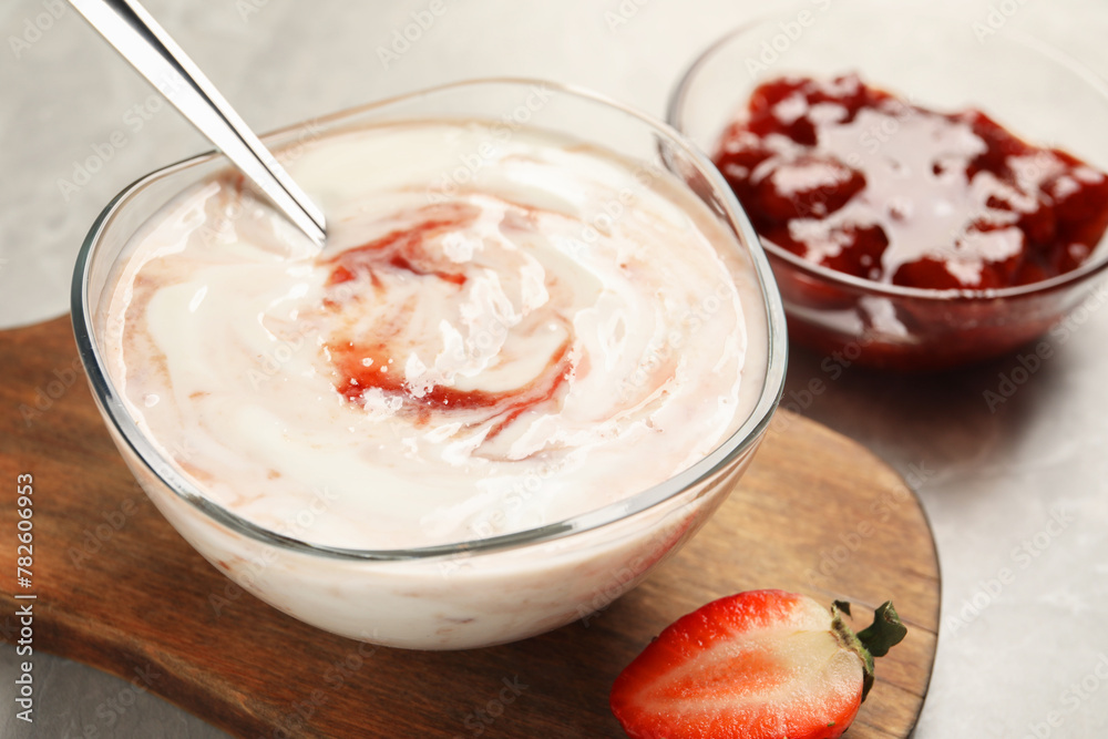 Tasty yoghurt with jam and strawberry on grey table, closeup Tasty yoghurt with jam and strawberry on grey table, closeup