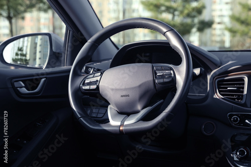 Black steering wheel inside of modern car © New Africa