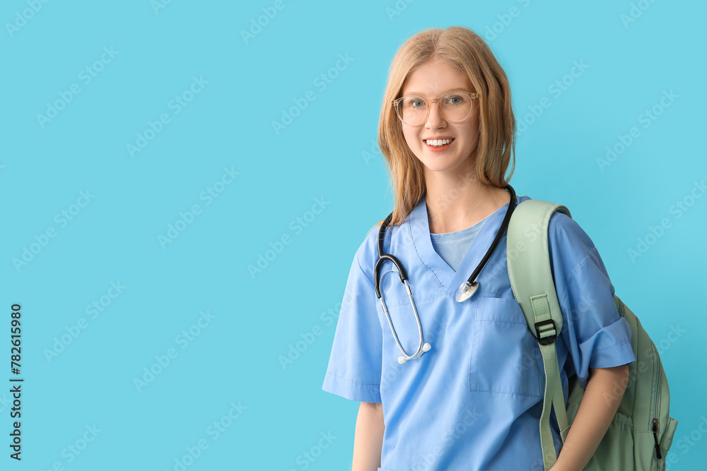 Female happy medical assistant with stethoscope on blue background Female happy medical assistant with stethoscope on blue background