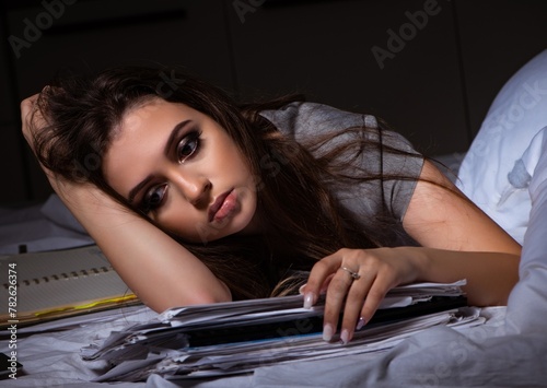 Tired businesswoman working overtime at home at night