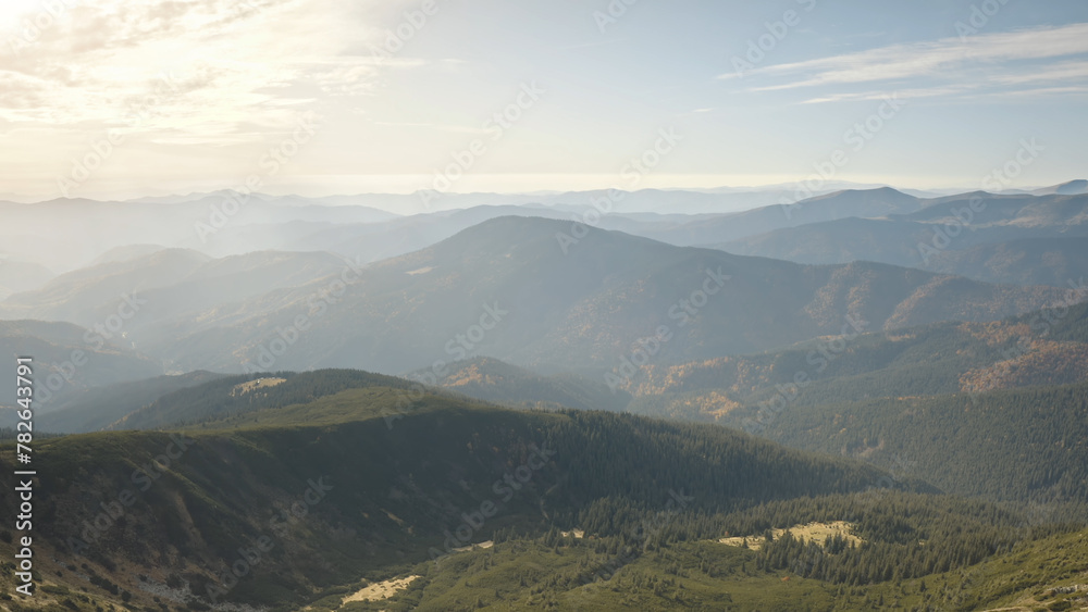 Naklejka premium Slow motion of mountain top aerial closeup. Nobody nature mist landscape. Autumn mount ridges at fog. Stones and rock at peak. Misty haze at Carpathians ranges, Ukraine, Europe. Cinematic environment