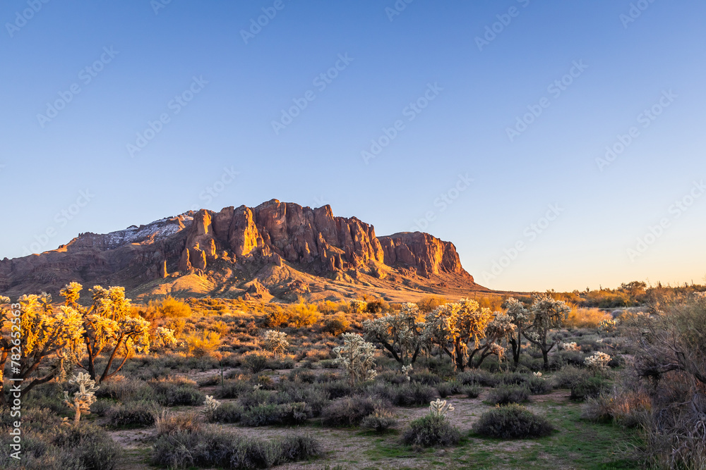 Evening photo of the Superstition Mountains in Arizona and clear blue sky.