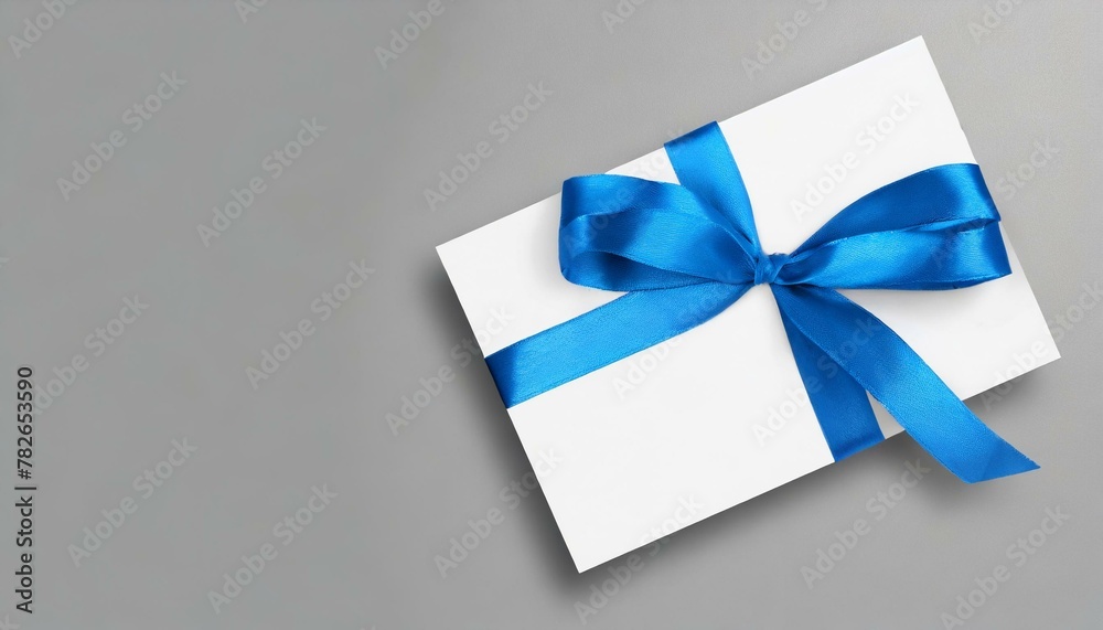 gift card with blue ribbon, blank blue gift card with a vibrant black ribbon bow right side, a minimalist grey background with subtle shadowing. 