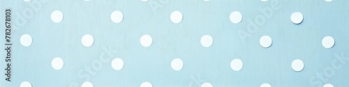 A banner featuring a light blue background with playful white polka dots. Banner. photo
