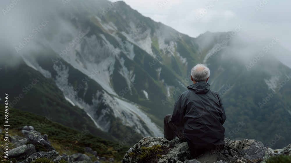 An old man Japanese with grey hair climbed a mountain by herself