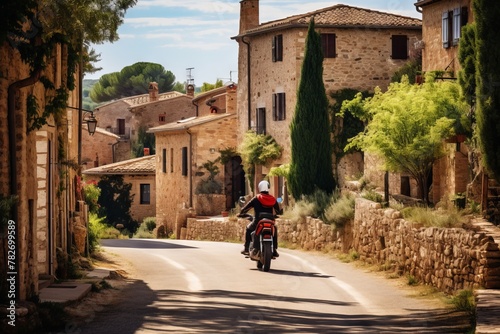 A biker cruising through a charming countryside village