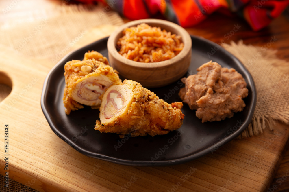 Chicken Cordon Bleu. Chicken breast meat wrapped with ham and cheese, breaded and fried or baked. Also known as schnitzel cordon bleu, a very popular recipe in many countries. Chicken Cordon Bleu. Chicken breast meat wrapped with ham and cheese, breaded and fried or baked. Also known as schnitzel cordon bleu, a very popular recipe in many countries.