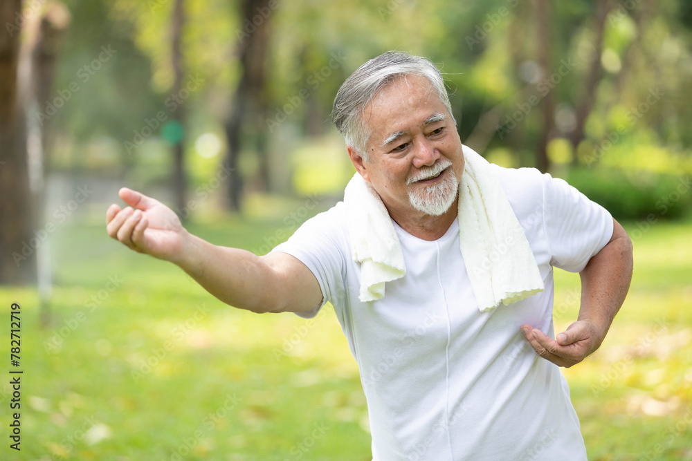 asian senior man workout and practice tai chi in the park asian senior man workout and practice tai chi in the park