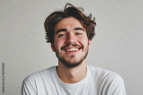 Portrait of a happy young man smiling and looking at the camera