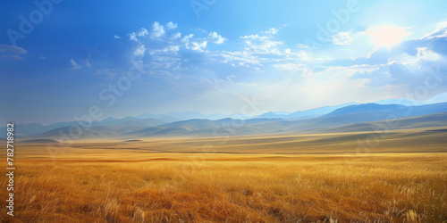 A vast expanse of grassland under the blue sky, with distant mountains in the background, is bathed in sunlight, creating a peaceful and serene scene.