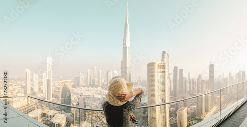 Dubai, UAE - 12th october, 2022: Burj Khalifa View from sky view downtown, lady by infinity pool looking at the tallest building in the world. Visit Dubai sky view hotel on holiday