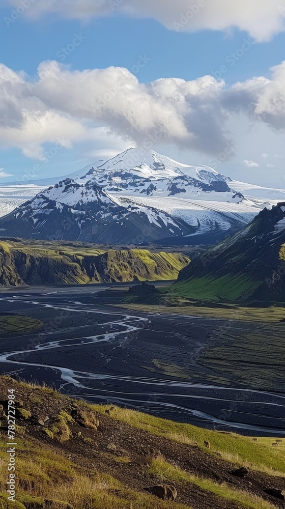 A panoramic view of snow-capped volcanic peaks, glaciers carving their way through the landscape