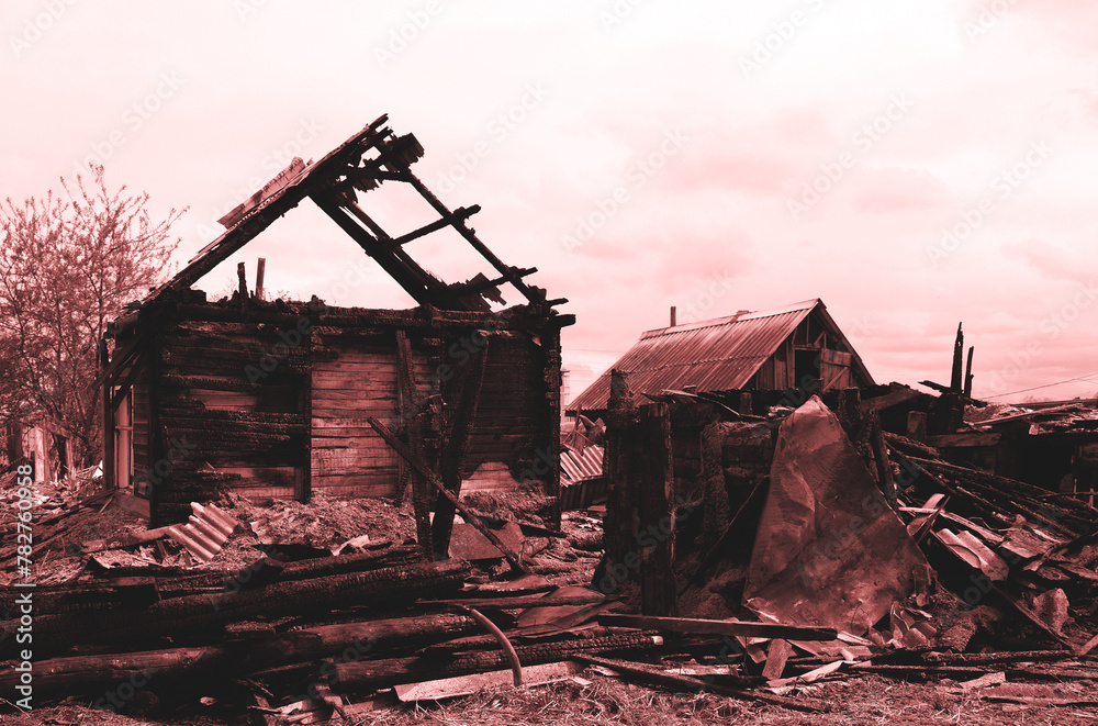 A Burned demolished house, View of a deserted run down wooden village house after a fire A Burned demolished house, View of a deserted run down wooden village house after a fire