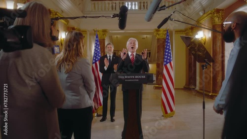 US presidential candidate says inspirational campaign speech in the White House, journalists applaud. Minister or congressman speaks at press conference for media and television. Election coverage.