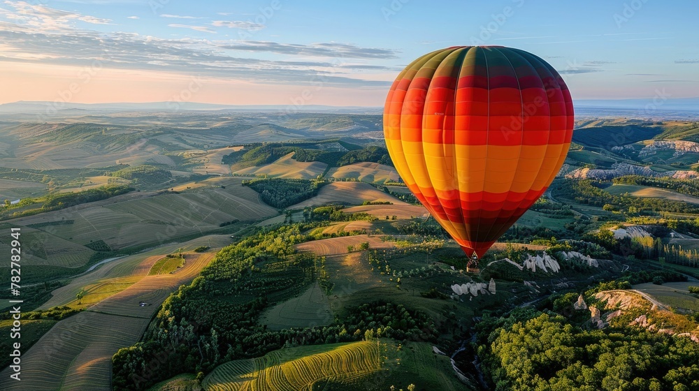 Naklejka premium Mesmerizing Hot Air Balloon Floating Over Picturesque Countryside Landscape With Vibrant Colors and Dramatic Skyscape at Sunrise or Sunset
