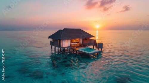 Sunset paints the Maldivian sky, reflecting its hues on calm, crystal-clear waters