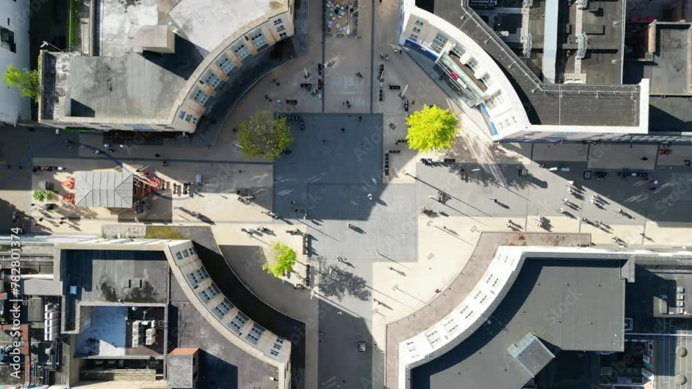Bird's-eye view of people in Bristol's city center, browsing shops and gathering in the town square. Bird's-eye view of people in Bristol's city center, browsing shops and gathering in the town square.