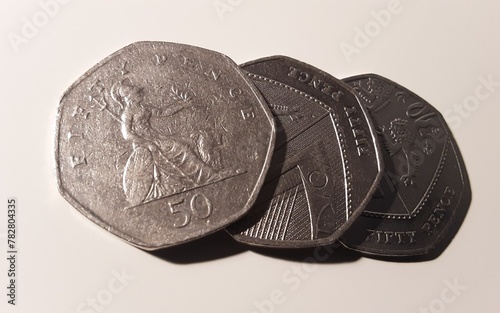 Three fifty pence coins on white. photo