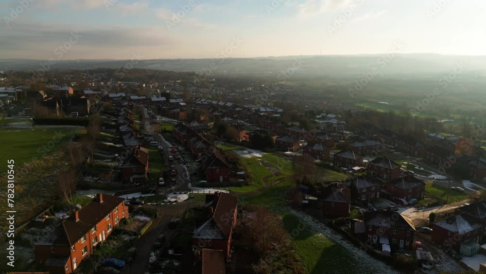 Drone's-eye winter view captures Dewsbury Moore Council estate's typical UK urban council-owned housing development with red-brick terraced homes and the industrial Yorkshire. Working class housing Drone's-eye winter view captures Dewsbury Moore Council estate's typical UK urban council-owned housing development with red-brick terraced homes and the industrial Yorkshire. Working class housing