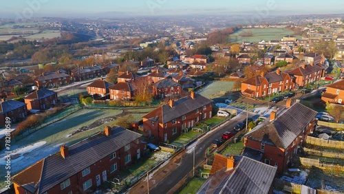 Drone's-eye winter view captures Dewsbury Moore Council estate's typical UK urban council-owned housing development with red-brick terraced homes and the industrial Yorkshire. Working class housing photo