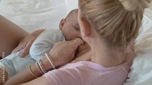 Tender moment between mother and newborn during breastfeeding in a soft-lit room