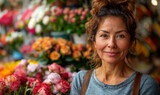 middle-aged brunette woman selling flowers in a flower shop, store owner entrepreneur portrait 