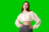 Confident Young Woman Posing With Hands on Hips Against Green Screen Background