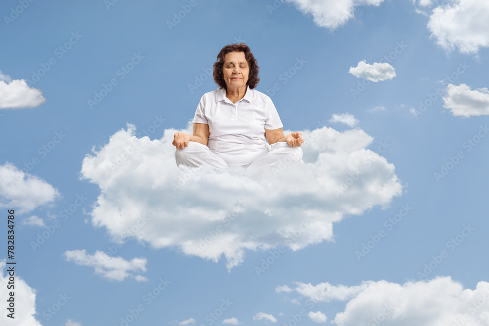 Elderly woman meditating on a cloud Elderly woman meditating on a cloud
