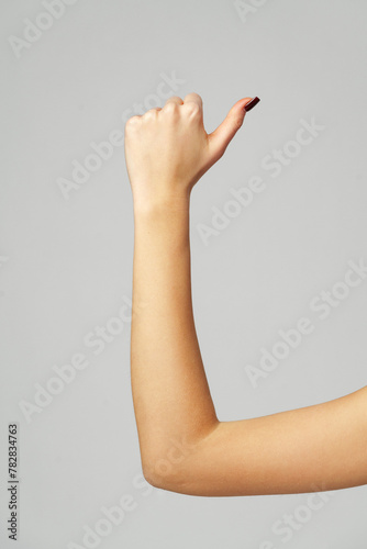 Female hand OK sign on gray background