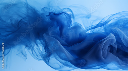 Abstract blue smoke forming fluid shapes on dark