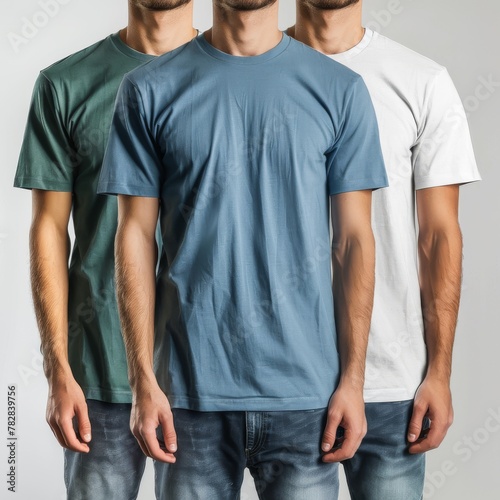 Three male models in green, blue, and white t-shirts