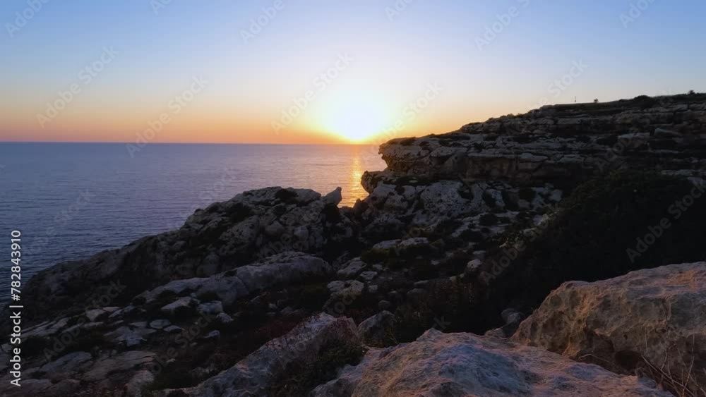 Expansive sea cliffs frame a stunning sunset in this wide-angle time-lapse Expansive sea cliffs frame a stunning sunset in this wide-angle time-lapse
