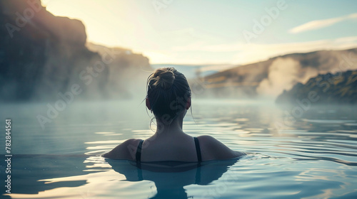 Young woman enjoying spa in hot springs in iceland