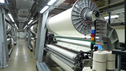 working weaving looms in a weaving factory workshop, fabric making, weaving