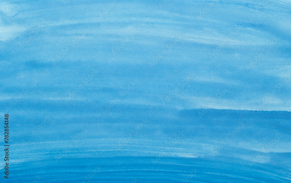 Naklejka premium Abstract blue watercolor background. The color splashing on the paper. Hand drawn.