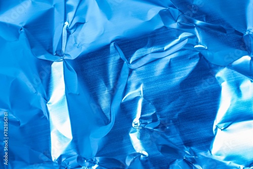 crumpled sheet metal painted blue. background or texture