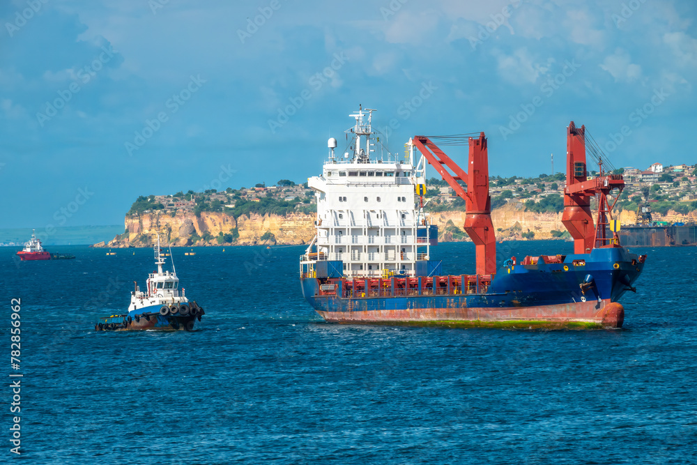 Busy container ship and tug boat traffic in the port of Luanda, Angola, Central Africa
