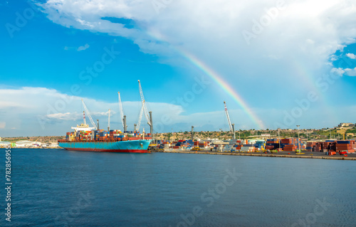 Double rainbow over the growing container ship harbor of Luanda, Angola, Central Africa