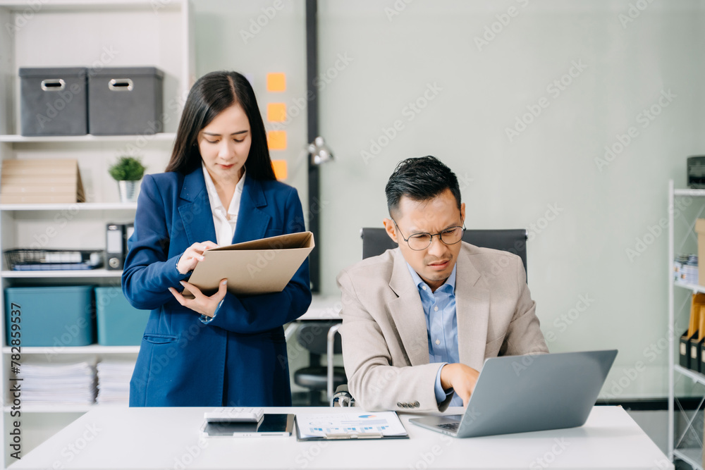 Furious two Asian businesspeople arguing strongly after making a mistake at work in office.. Furious two Asian businesspeople arguing strongly after making a mistake at work in office..