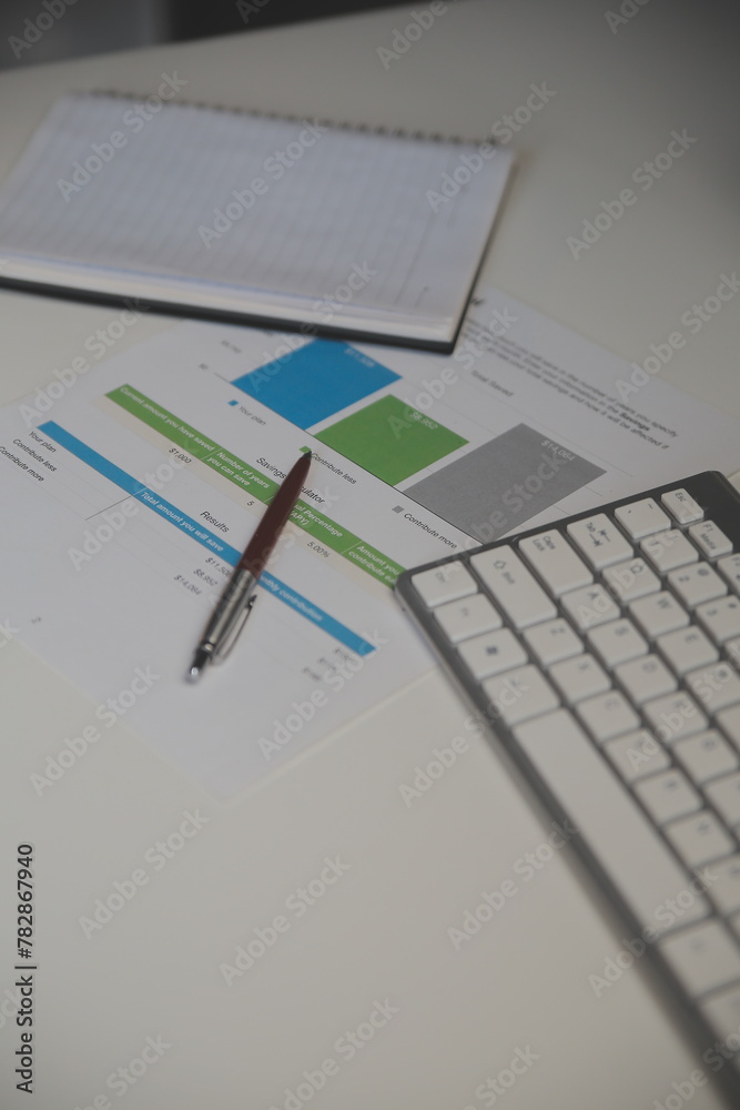 Laptop and paperwork on conference table Laptop and paperwork on conference table