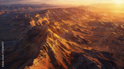 An expansive mockup of a desert mountain landscape at sunset, with warm, golden hues illuminating the rugged terrain, suitable for adventure travel and outdoor exploration brands.  photo