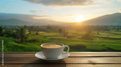Hot coffee cups on wooden table with morning rice field background