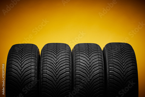 Car tires, winter wheels isolated on yellow background and screwdriver © ValentinValkov