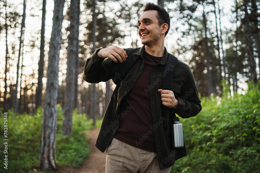 One caucasian male hiking in the woods