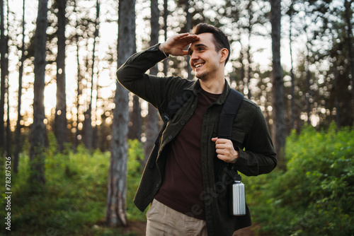 One caucasian male hiking in the woods